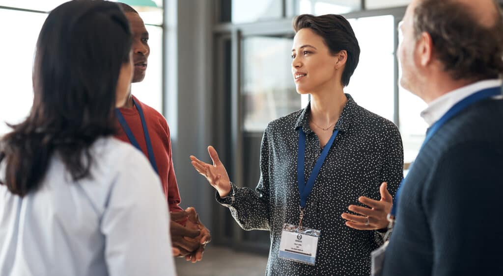 Shot of a group of businesspeople networking at a conference
